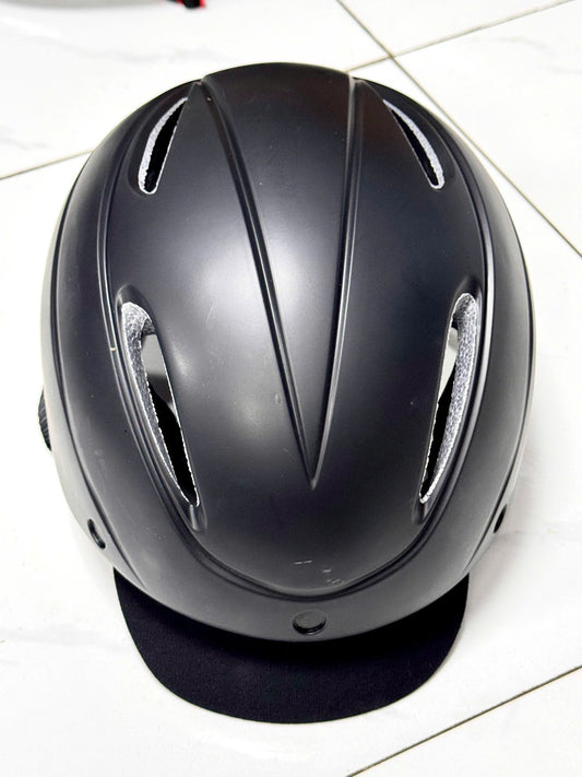 Black bicycle helmet with visor as pictured (minor dent, does not affect functionality) - Size L (57–62 cm)